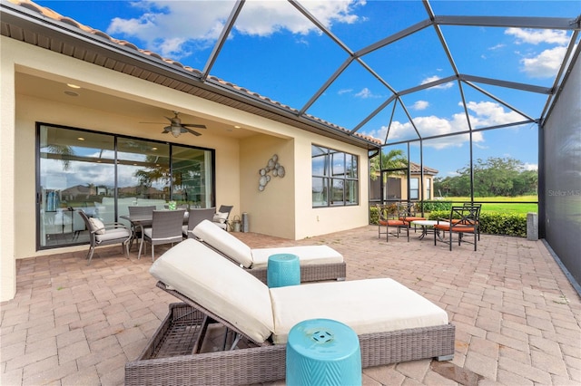 view of patio / terrace with glass enclosure, ceiling fan, and an outdoor hangout area