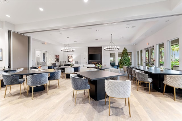 dining space featuring light hardwood / wood-style floors and a notable chandelier