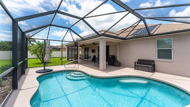 view of pool with a patio area, a lanai, and ceiling fan