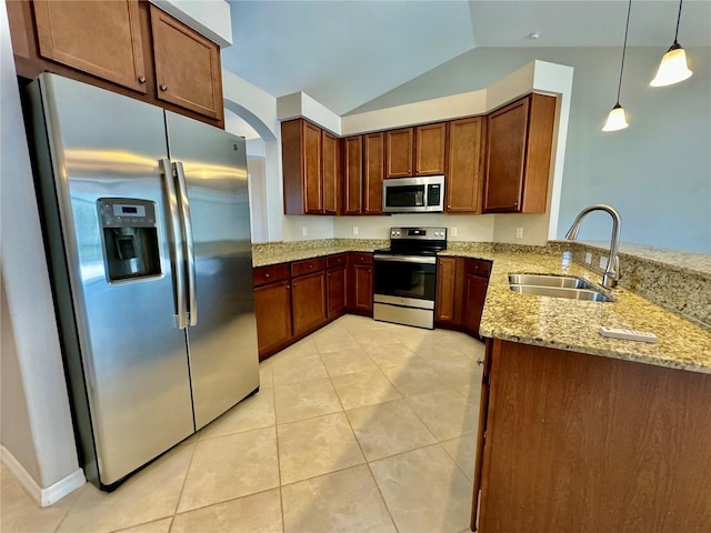 kitchen with appliances with stainless steel finishes, light stone countertops, vaulted ceiling, pendant lighting, and sink