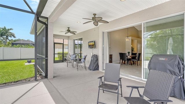 sunroom featuring ceiling fan