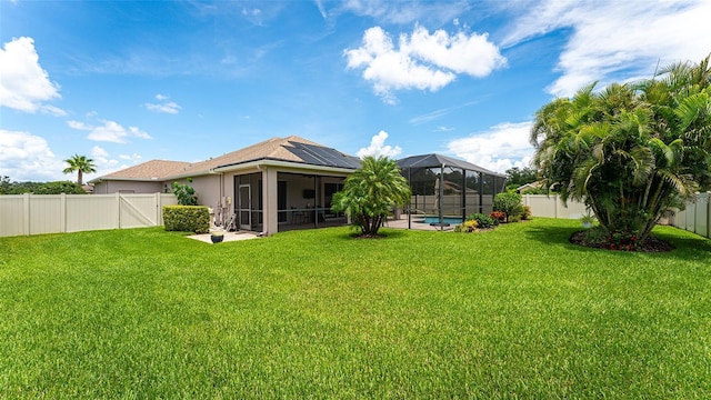 view of yard with a patio, a lanai, and a fenced in pool