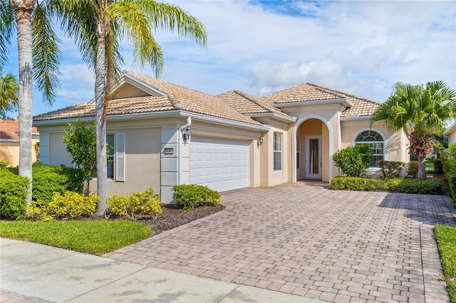 mediterranean / spanish-style house featuring a garage