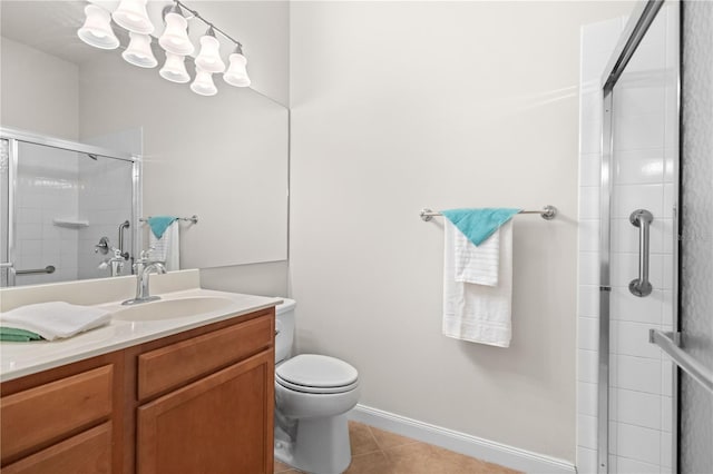 bathroom featuring vanity, toilet, tile patterned floors, and a shower with shower door