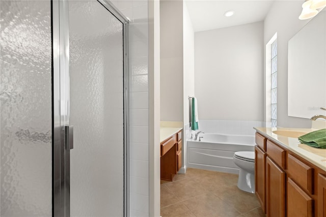 full bathroom featuring tile patterned floors, separate shower and tub, toilet, and vanity