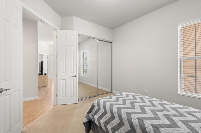 tiled bedroom with a closet