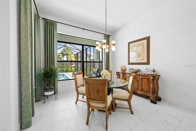 dining room with a notable chandelier and crown molding