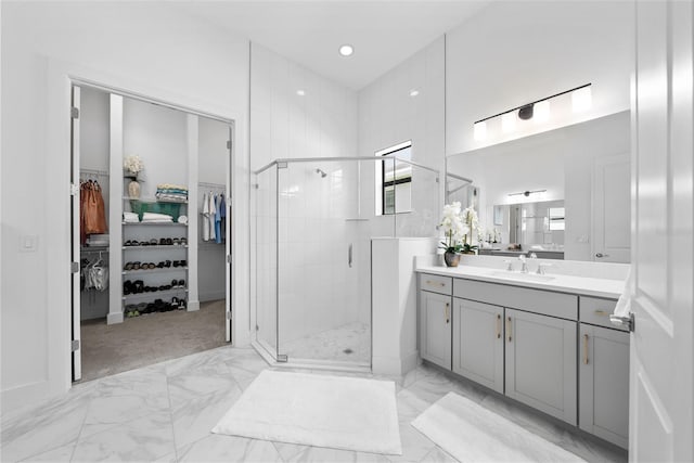 bathroom with vanity and a shower with shower door