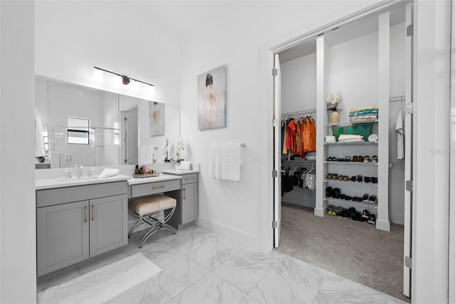 bathroom with walk in shower and vanity