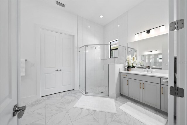 bathroom with vanity and a shower with shower door