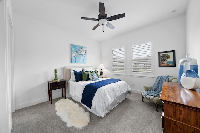 bedroom with ceiling fan and light colored carpet