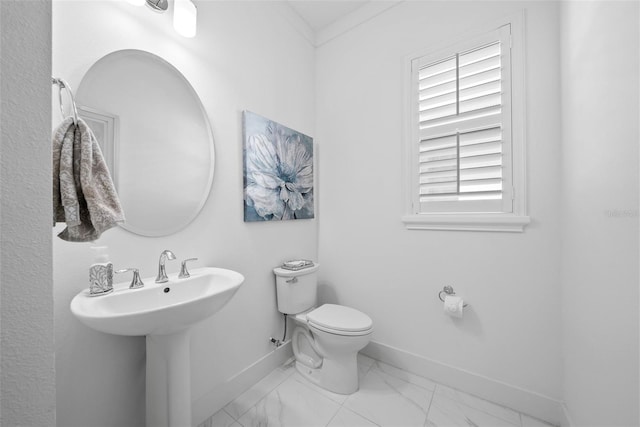 bathroom with ornamental molding and toilet