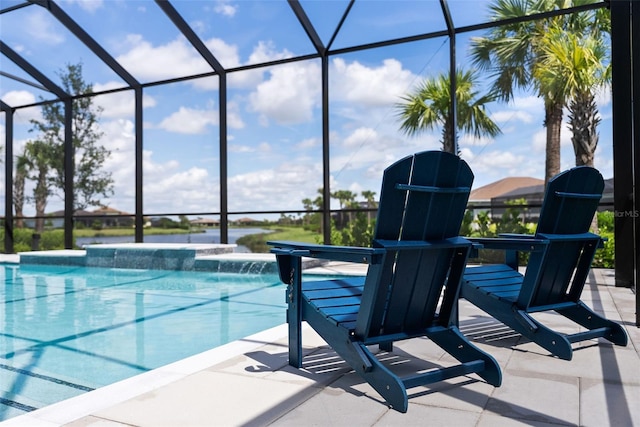 view of pool with glass enclosure, pool water feature, and a patio area