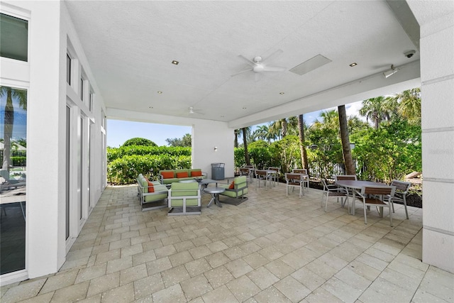 view of patio with ceiling fan and an outdoor living space