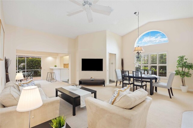 4995 Pepperwood Pl, Venice, FL 34293 - carpeted living area with baseboards, high vaulted ceiling, and a ceiling fan