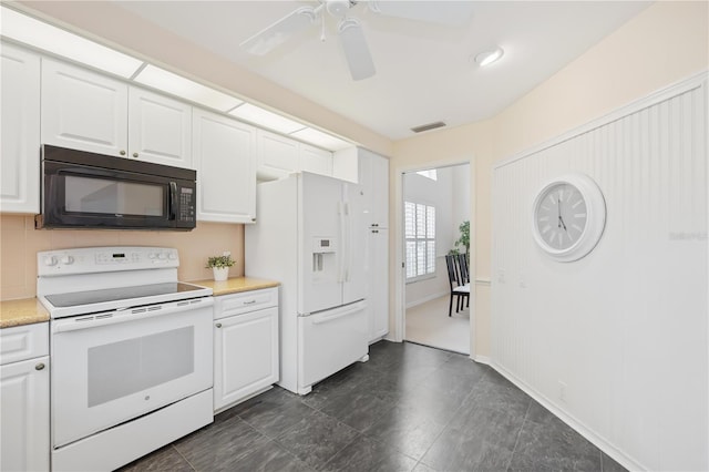 4995 Pepperwood Pl, Venice, FL 34293 - kitchen with light countertops, visible vents, white appliances, a ceiling fan, and white cabinetry