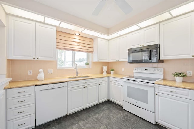 4995 Pepperwood Pl, Venice, FL 34293 - kitchen featuring white cabinetry, a sink, tasteful backsplash, and white appliances
