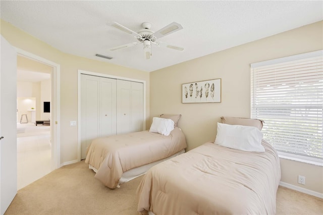 4995 Pepperwood Pl, Venice, FL 34293 - bedroom featuring a closet, visible vents, baseboards, a ceiling fan, and light colored carpet