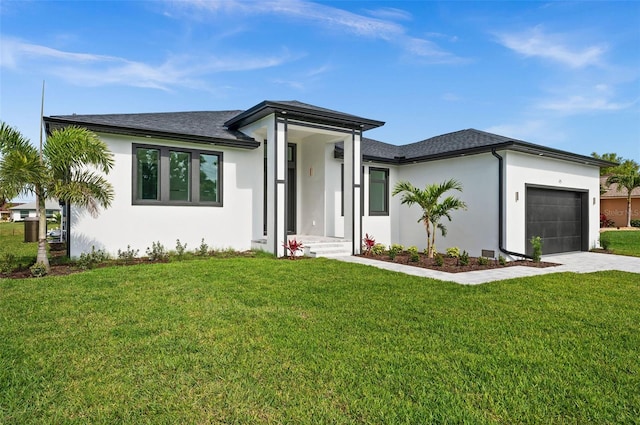 view of front of house featuring a garage and a front lawn