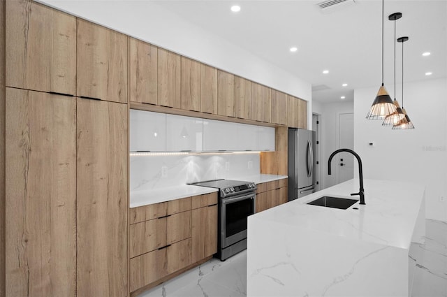 kitchen featuring pendant lighting, a spacious island, light stone counters, sink, and appliances with stainless steel finishes