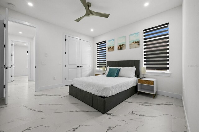 bedroom with ceiling fan and a closet