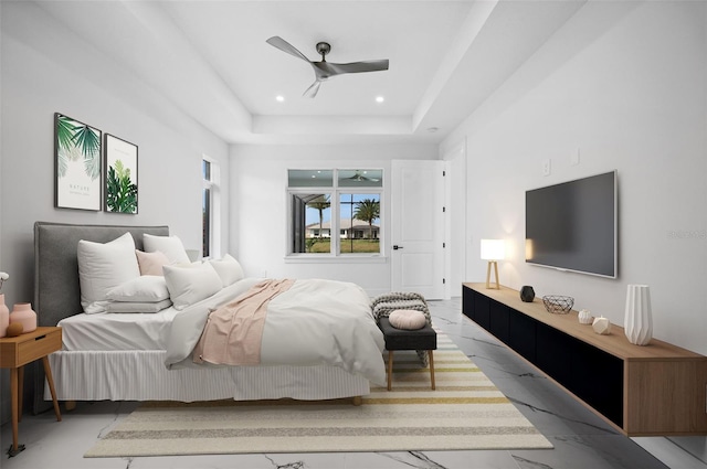 bedroom featuring a raised ceiling and ceiling fan