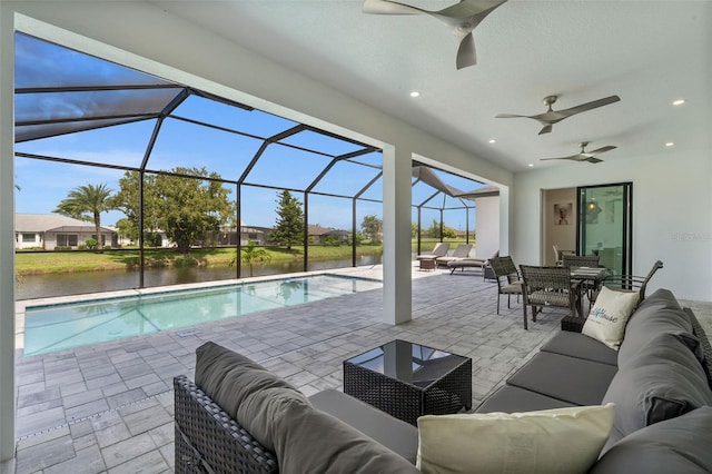 view of swimming pool featuring an outdoor living space, a patio area, ceiling fan, and a water view