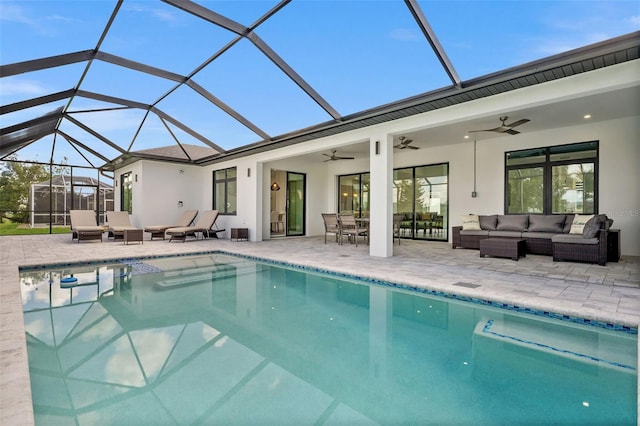 view of pool featuring an outdoor living space, a lanai, a patio, and ceiling fan