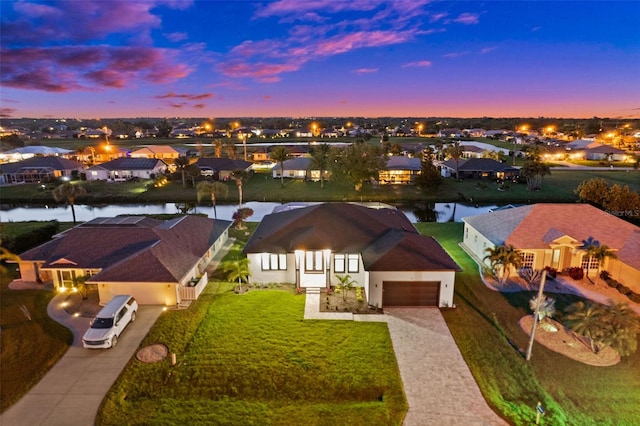 aerial view at dusk with a water view