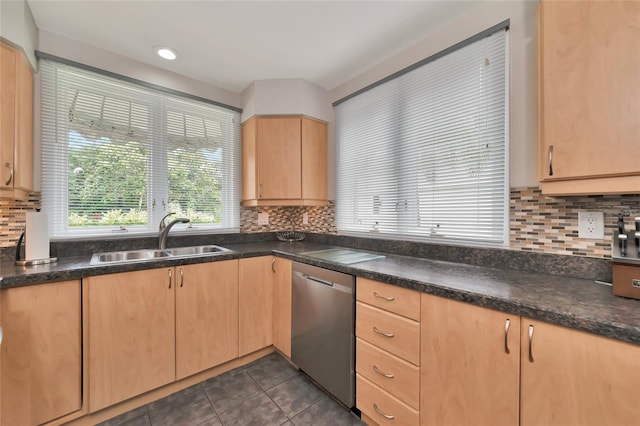 kitchen with light brown cabinetry, dishwasher, sink, decorative backsplash, and dark tile patterned floors