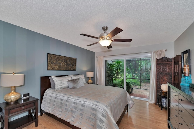 bedroom featuring a textured ceiling, access to outside, light hardwood / wood-style floors, and ceiling fan