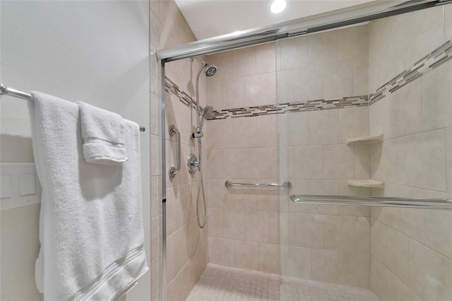 bathroom featuring a shower with door