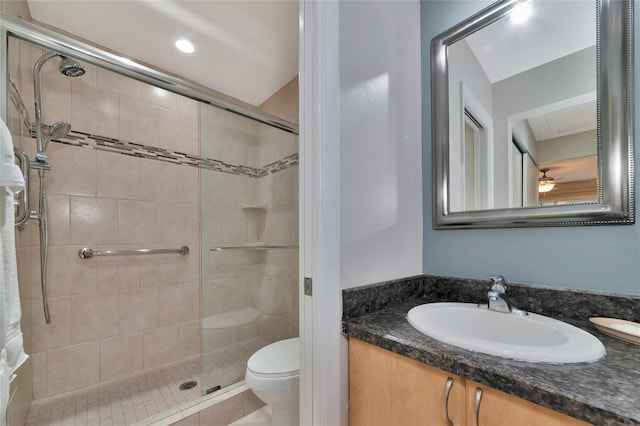 bathroom featuring vanity, a shower with shower door, tile patterned floors, and toilet