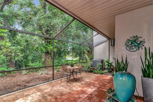 view of patio with a lanai and central AC