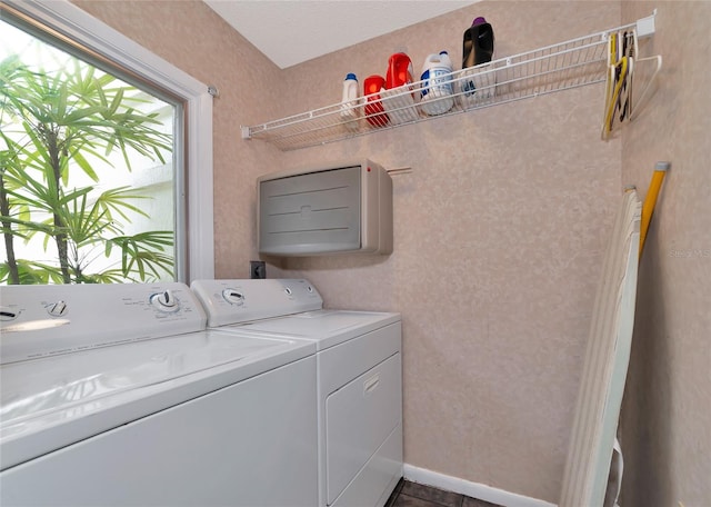 laundry area featuring dark tile patterned flooring and washer and clothes dryer