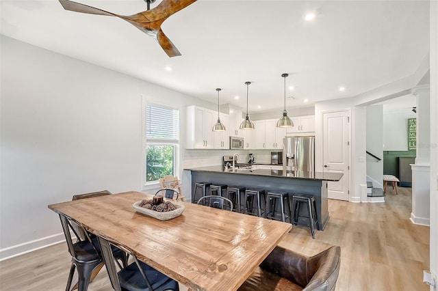 dining area featuring a ceiling fan, recessed lighting, light wood-style flooring, and baseboards