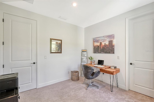 carpeted home office featuring visible vents and baseboards