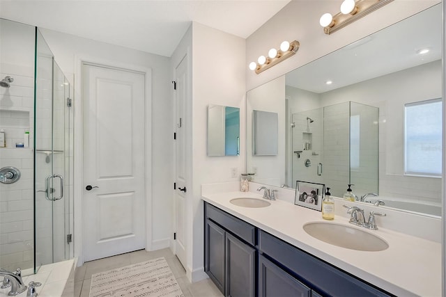 bathroom featuring a sink, a shower stall, a bathing tub, and double vanity