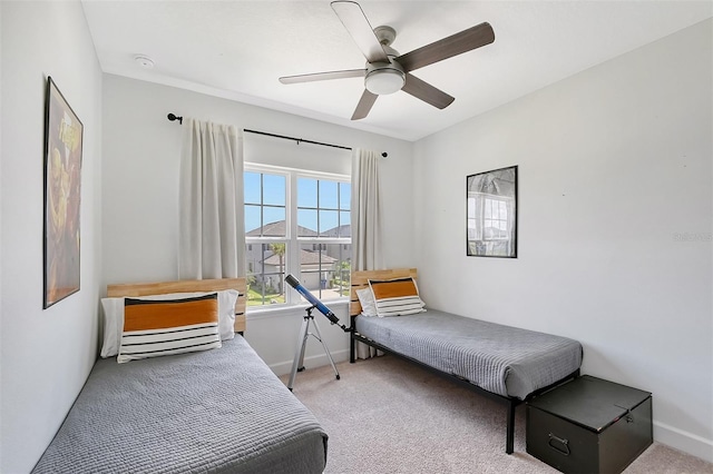 bedroom featuring carpet floors, a ceiling fan, and baseboards