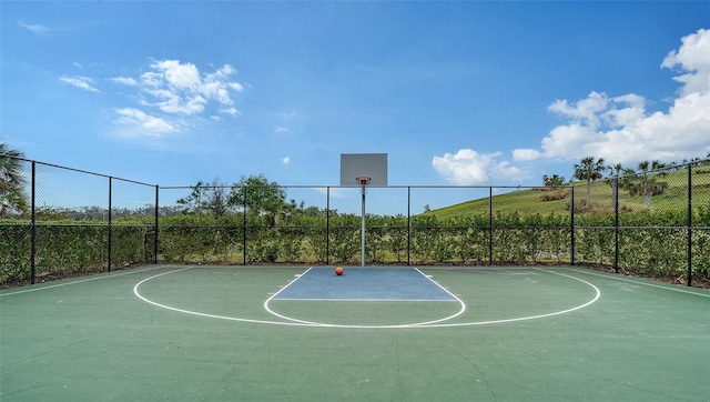 view of basketball court with community basketball court and fence