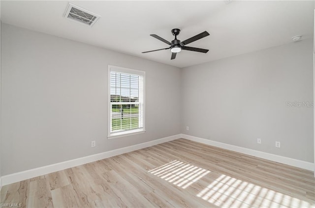 empty room with ceiling fan and light hardwood / wood-style flooring