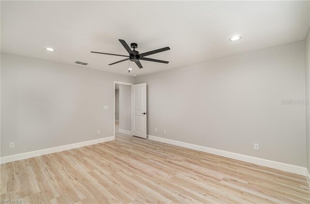 empty room featuring ceiling fan and light wood-type flooring