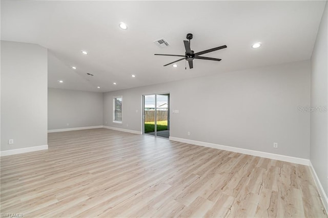 unfurnished room with lofted ceiling, ceiling fan, and light hardwood / wood-style flooring