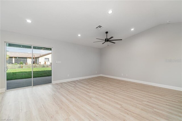 empty room featuring light wood-type flooring, vaulted ceiling, and ceiling fan