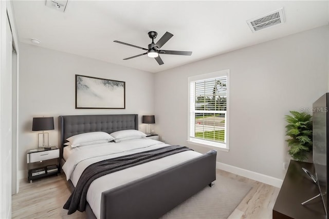 bedroom with light wood-type flooring and ceiling fan