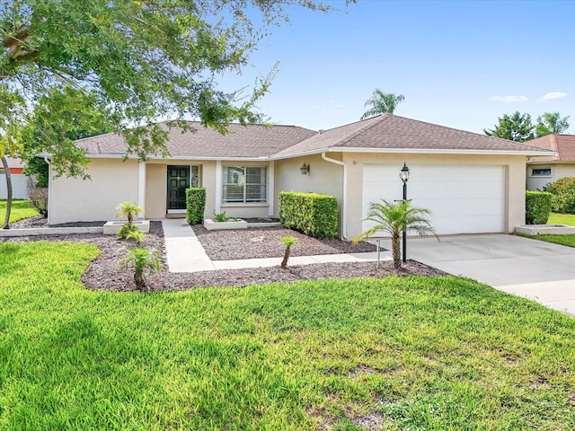 single story home with a front yard and a garage