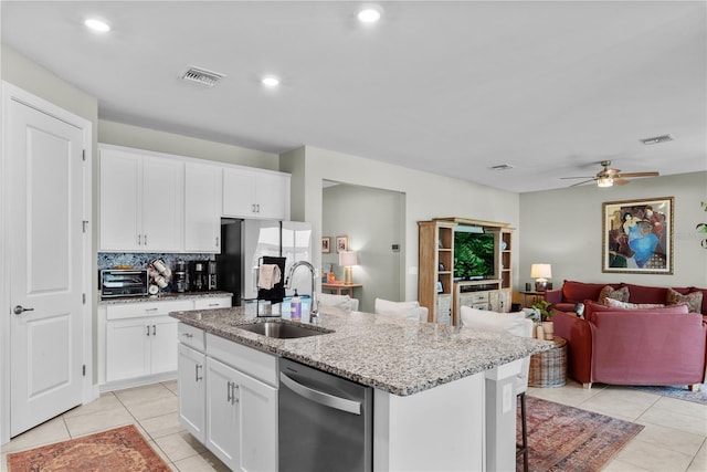 kitchen featuring white cabinets, a kitchen island with sink, appliances with stainless steel finishes, and sink