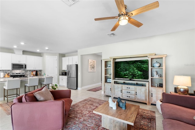 living room with ceiling fan and light tile patterned flooring