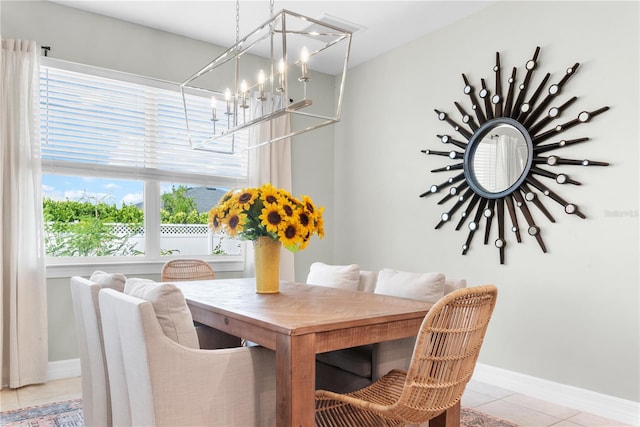 tiled dining area with an inviting chandelier and plenty of natural light