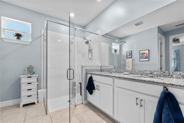 bathroom with vanity, a shower with shower door, and tile patterned flooring